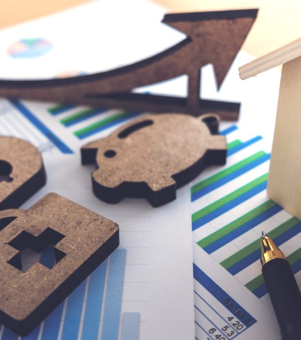 financial banking stock spreadsheet with house, piggy, medical, money and pen on accountant data, growth rate, finance, saving, investment, business and banking concept.